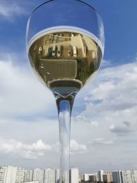 Low angle view of beer glass against sky