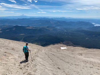 Full length of man walking on mountain against sky