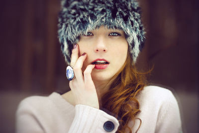 Portrait of young woman wearing hat