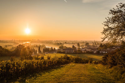 Scenic view of field against sky during sunset