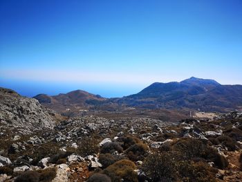 Scenic view of mountains against clear blue sky