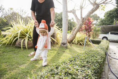 Rear view of father and son on plant