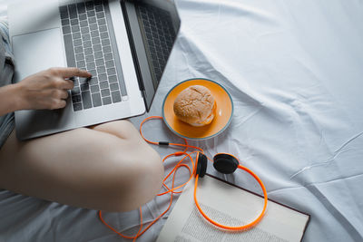 Midsection of woman using laptop