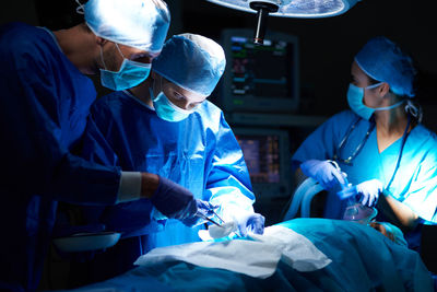 Surgeons operating patient