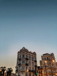 Low angle view of buildings against clear sky