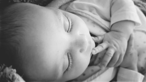 Close-up of baby sleeping on bed