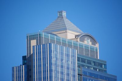Low angle view of building against clear blue sky