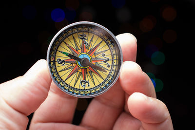 Close-up of hand holding navigational compass