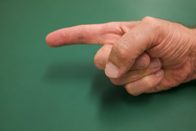 Close-up of person hand against gray background