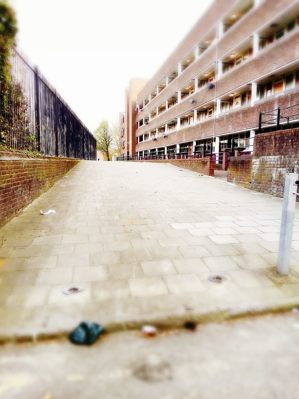 architecture, built structure, the way forward, diminishing perspective, building exterior, surface level, clear sky, vanishing point, walkway, railing, day, sky, empty, selective focus, outdoors, pathway, narrow, long, footpath, no people