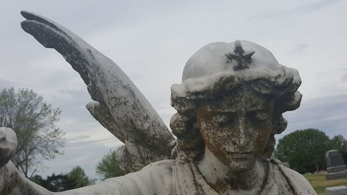 Low angle view of statue against sky