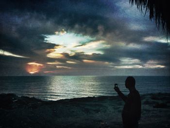 Scenic view of sea against cloudy sky