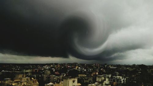 Cityscape against cloudy sky