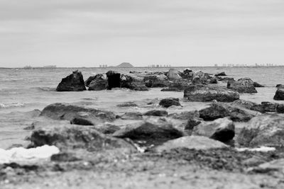 Rocks on beach against sky