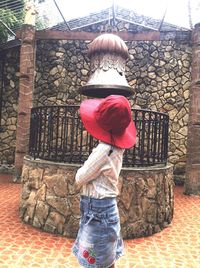 Rear view of woman standing in front of tree