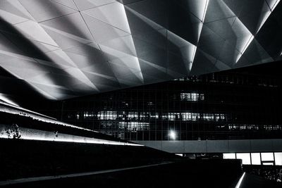 Low angle view of illuminated railroad station at night
