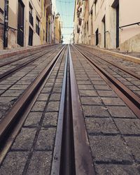 Surface level of railroad tracks amidst buildings in city