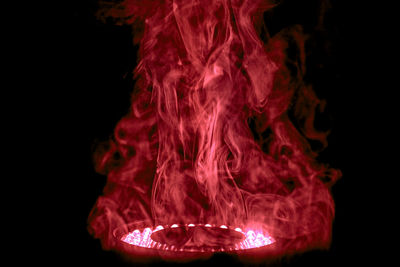 Close-up of illuminated fire against black background