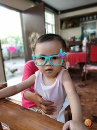 Portrait of cute girl on table