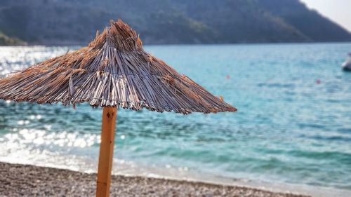 Close-up of parasol on beach