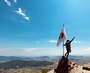 Man standing on mountain against sky