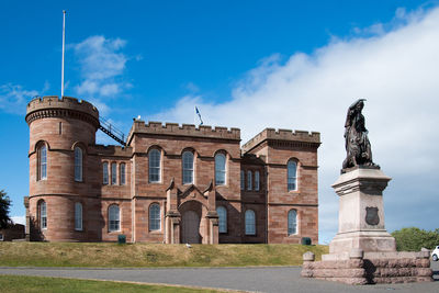 Low angle view of historical building against blue sky