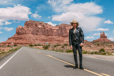 Man standing on road against sky