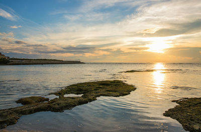 Scenic view of sea against sky at sunset