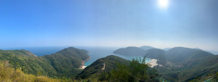 Panoramic view of mountains against blue sky