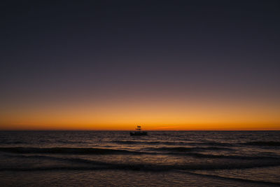 Scenic view of sea against clear sky during sunset