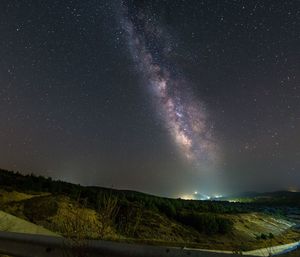 Scenic view of mountains against star field at night