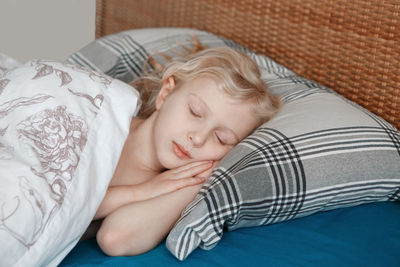 Baby boy sleeping in bed