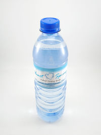 Close-up of glass bottle against white background