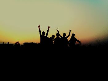 Silhouette people against clear sky during sunset