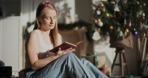 Young woman using mobile phone at home