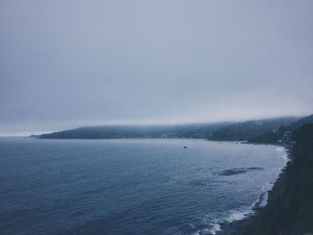 Scenic view of lake against sky in foggy weather