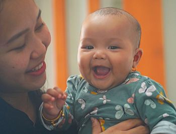 Close-up of cute baby girl at home