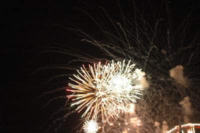 Low angle view of firework display at night