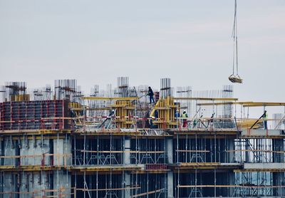 Construction site in city against sky