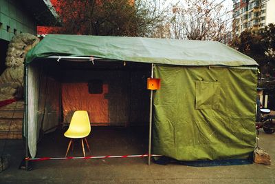 Rear view of man sitting in tent