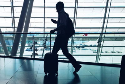 Side view of man walking at airport