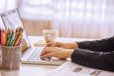 Close-up of man using laptop