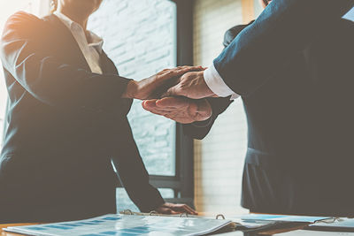 Colleagues stacking hands in office