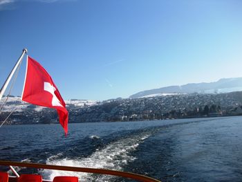 Boats in sea against clear sky