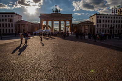 People at historic brandenburg gate against sky