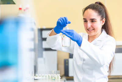 Portrait of smiling young woman in laboratory