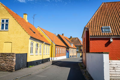 Street amidst buildings in town against sky