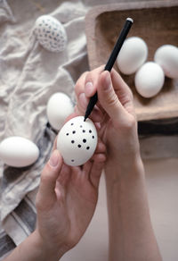 Cropped hand of person holding egg