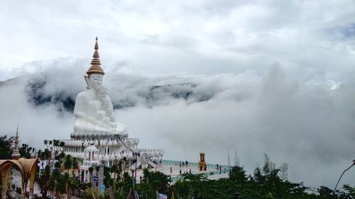 Statue of temple against cloudy sky