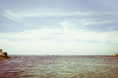 Scenic view of sea against cloudy sky